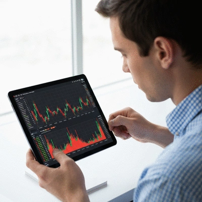 Person looking at crypto charts on a tablet, showing market volatility